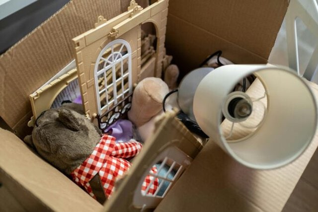 Parent and child sorting toys during a decluttering session