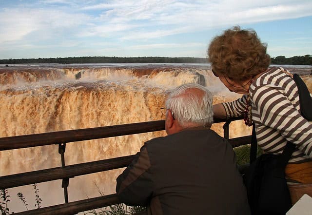 Visitors admiring Iguazu Falls from the viewing platform.