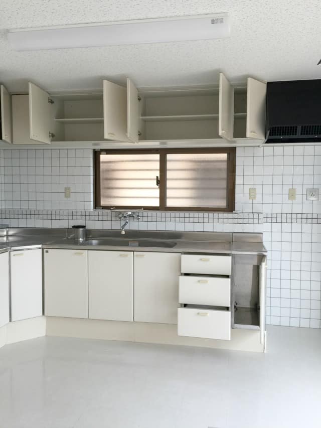 okinawa rental house kitchen with white cabinets, floors, and walls