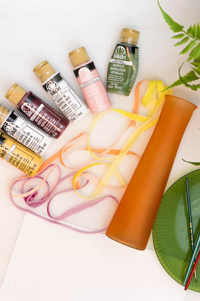 small glass vase and paint and ribbon