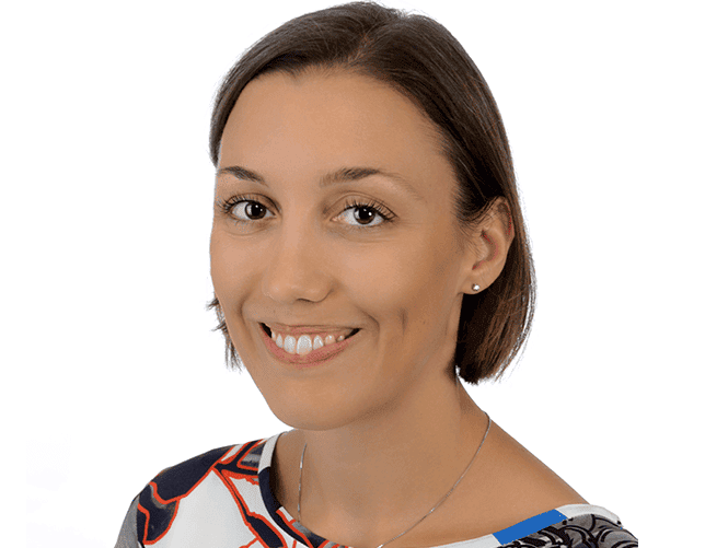 Professional woman smiling, representing data analytics and insights.