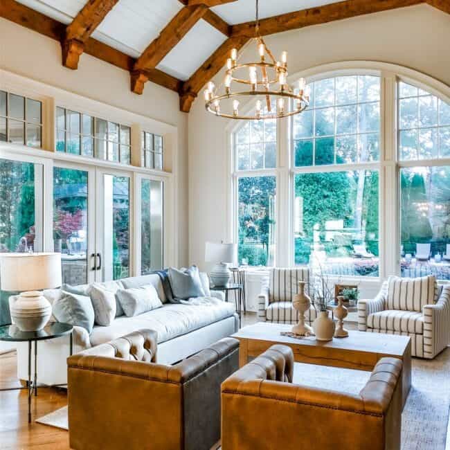 Bright, airy living space with elegant chandelier and cozy seating area.