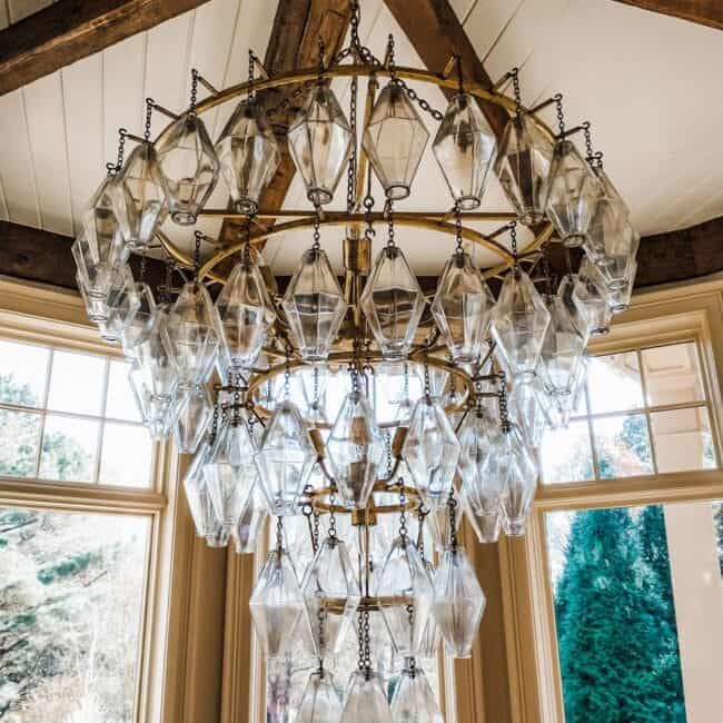 Elegant vintage crystal chandelier in a sunlit room.