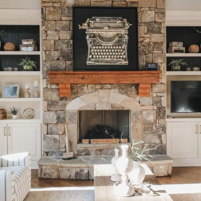 Versatile living room fireplace with surrounding shelves and cozy decor accents.