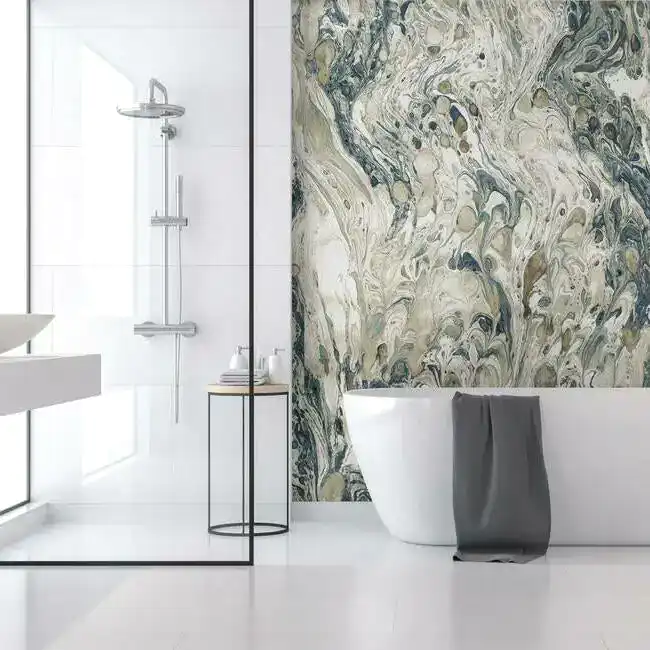 Contemporary bathroom interior with marble accent wall, freestanding tub, and glass shower enclosure.