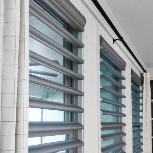 Modern exterior window shutters with adjustable louvers and window blinds for privacy.