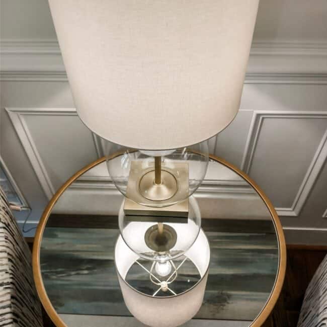 Modern home decor, stylish lighting, glass base lamp, neutral tones, living room accessory.