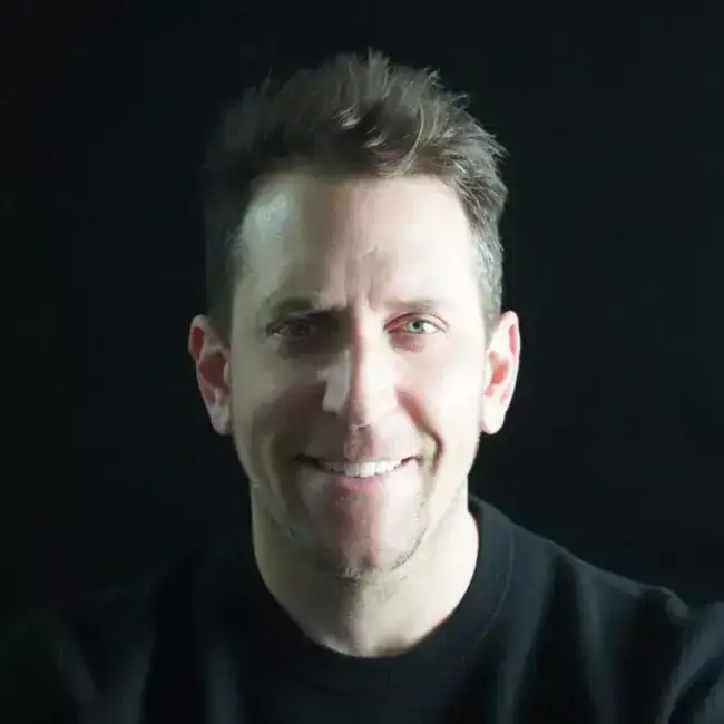 Interior hallway with natural light, concrete walls, minimalist design, and wooden flooring.