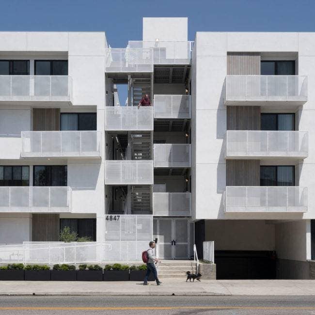 Exterior view of Los Angeles TOC housing in Larchmont designed by Bittoni Architects, showing contemporary massing and balconies facing the street.