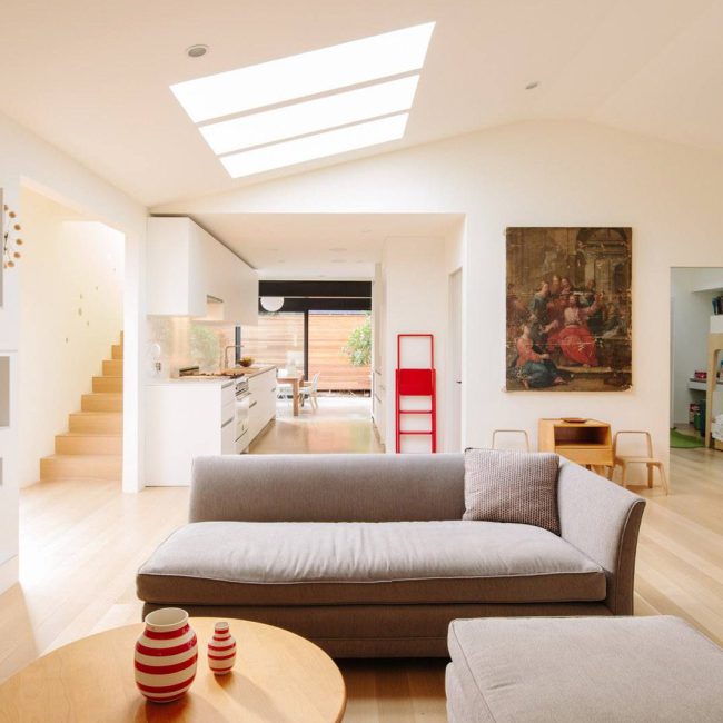 Bright modern residential living room with skylights and contemporary decor.