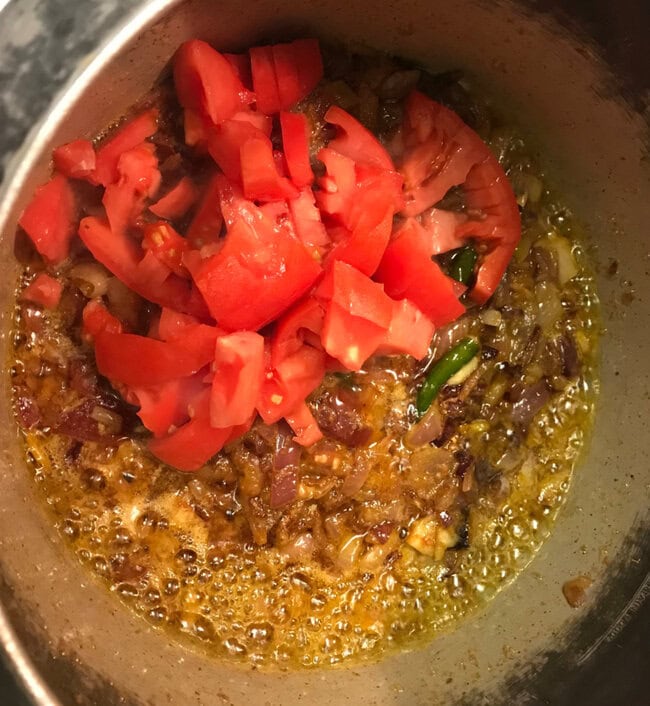 add tomatoes to goat curry