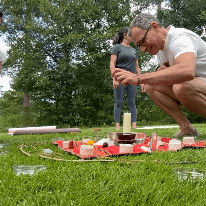 Mindfulness outdoor gathering, peaceful spiritual connection at Soulstice Living, group yoga, meditation, wellness retreat in nature, people practicing mindfulness in lush green park, community wellness event, holistic health, relaxation, self-care.