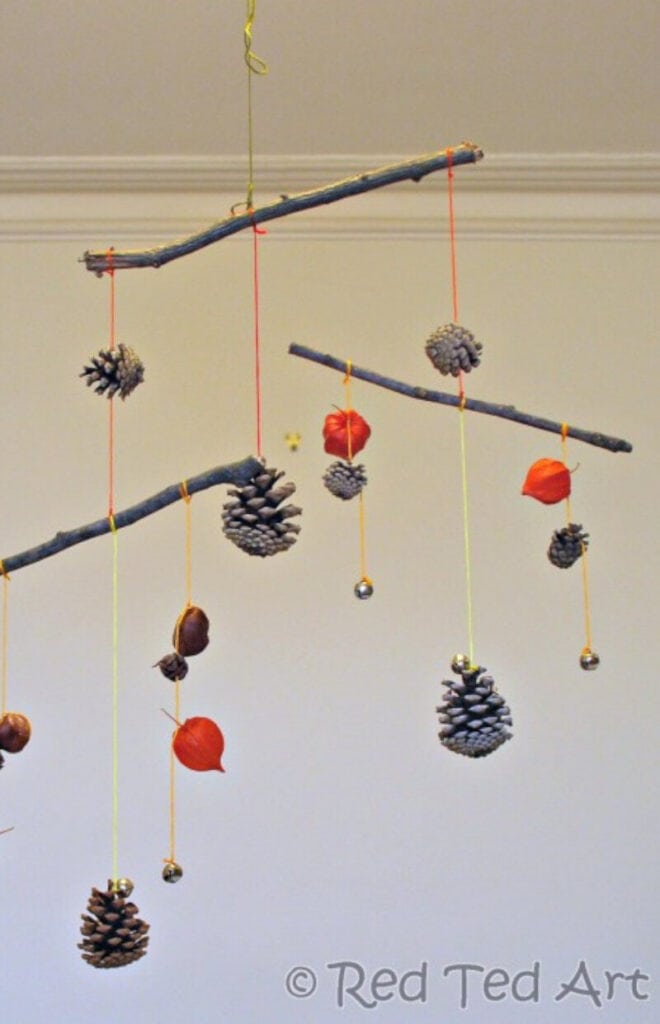 fall-themed mobile DIY craft for kids using pinecones, twigs and acorns