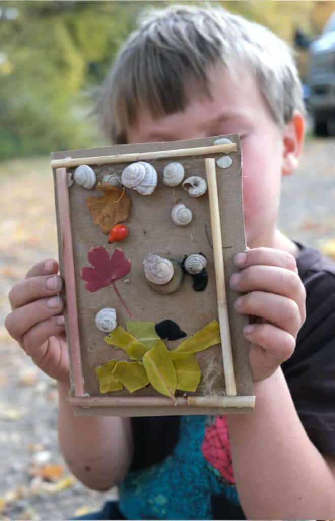 Children's DIY art project using natural elements featuring rocks, leaves and twigs.