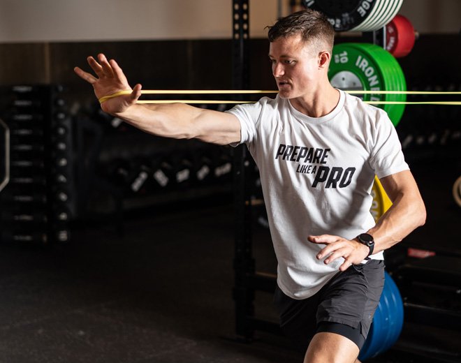 Jack McLean in action, performing resistance band exercises at the Prepare Like a Pro gym.
