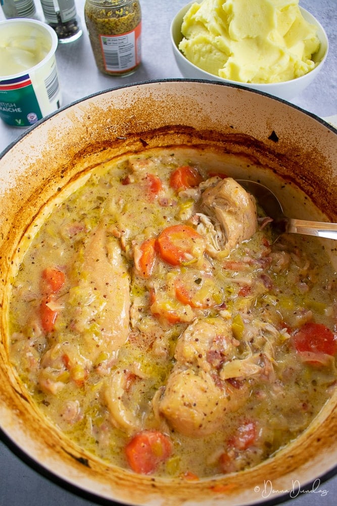 3/4 shot close up of casserole in cooking dish, mashed potato in background