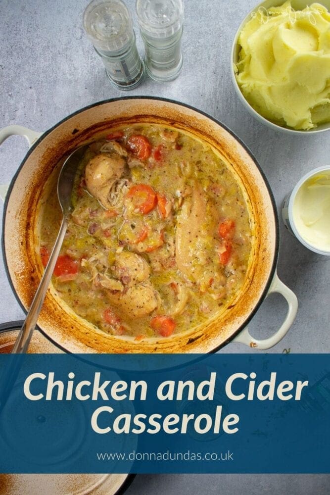 Chicken and cider casserole in cast iron dish with mash to the side.