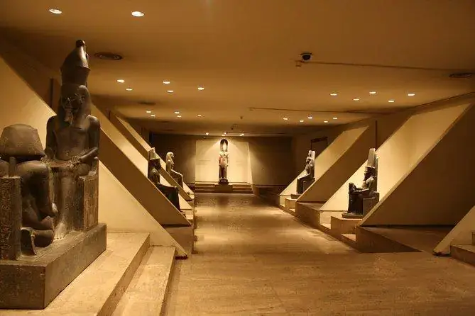 Illuminated corridor lined with ancient statues