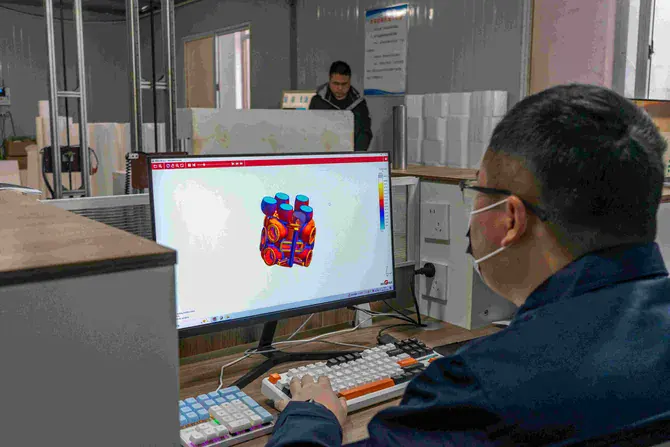 Technician reviewing 3D dimensional inspection data for a custom furnace casting