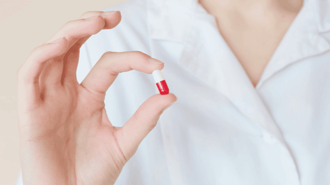 Nurse holding a pill