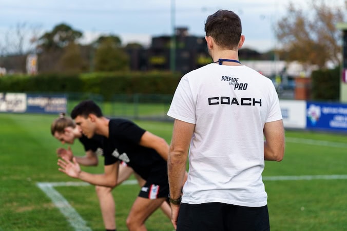 Coach providing one-on-one Speed Training to improve sprint mechanics