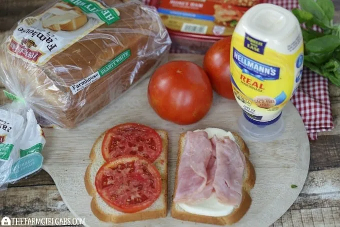 This Caprese Ham Panini scores big points! Tomatoes, mozzarella, ham and a basil spread are sandwiched between two slices of Pepperidge Farm bread and grilled to perfection. #SandwichWithTheBest www.thefarmgirlgabs.com