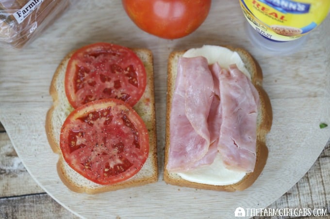 This Caprese Ham Panini scores big points! Tomatoes, mozzarella, ham and a basil spread are sandwiched between two slices of Pepperidge Farm bread and grilled to perfection. #SandwichWithTheBest www.thefarmgirlgabs.com