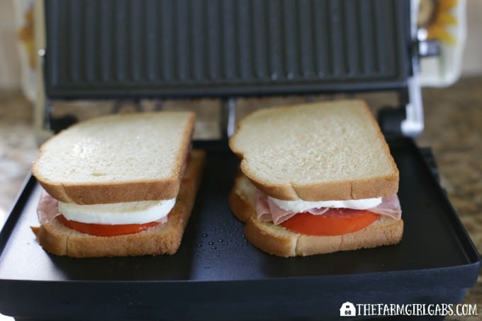 This Caprese Ham Panini scores big points! Tomatoes, mozzarella, ham and a basil spread are sandwiched between two slices of Pepperidge Farm bread and grilled to perfection. #SandwichWithTheBest www.thefarmgirlgabs.com