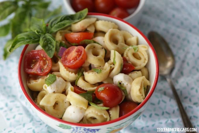 Turn pizza night into party night with this delicious Caprese Tortellini Salad. This recipe is the perfect quick side dish for a weeknight dinner or party.