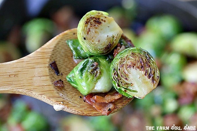 Pan Seared Brussels Sprouts With Bacon are a super quick side dish ready in 20 minutes flat! It's the perfect recipe to serve at Thanksgiving or for a weeknight meal. #SideDish #Recipe