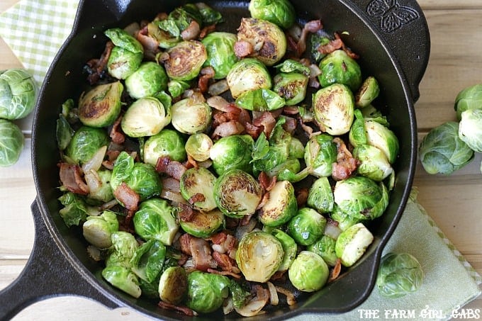 Pan Seared Brussels Sprouts With Bacon are a super quick side dish ready in 20 minutes flat! It's the perfect recipe to serve at Thanksgiving or for a weeknight meal. #SideDish #Recipe