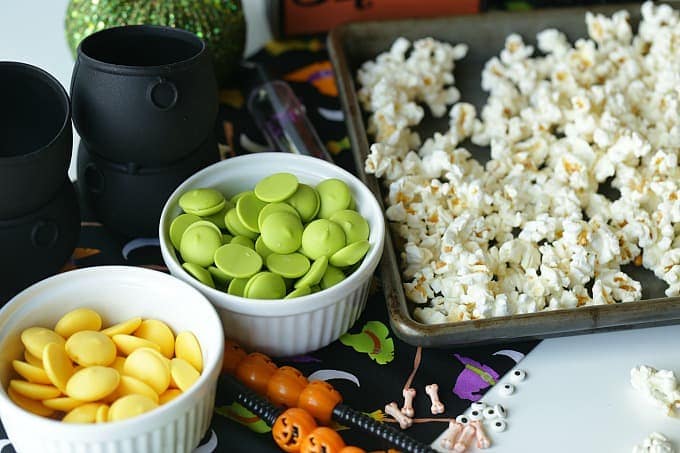 Double, double toil and trouble, Fire burn, and cauldron bubble. Stir up a batch of this ghoulish Cauldron Corn for some Halloween fun. #Halloween #Halloweenparty #HalloweenCandy #Snacks #Popcorn