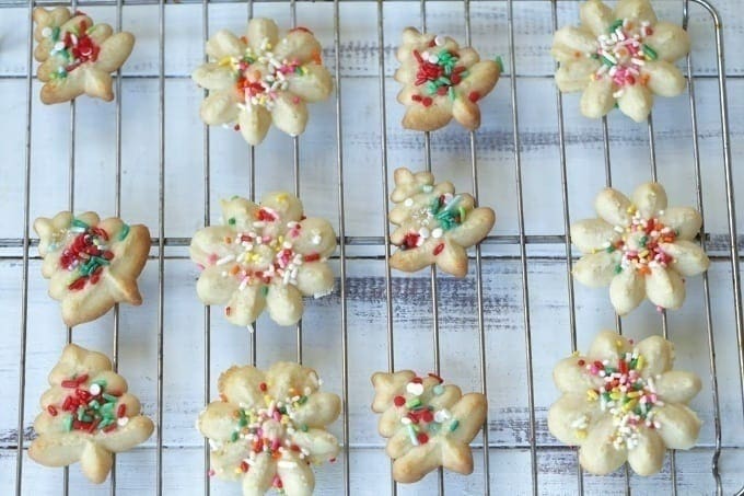 These classic Spritz Cookies are rich, buttery and a must-have cookie for Christmas. Rumor has it that they are Santa's favorite too. #SpritzCookies #ChrismtasCookies #CookieRecipe #holidaybaking #holidayrecipes #Christmascookieexchange #Christmascookierecipe