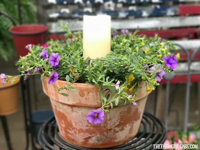 Beautify your backyard decor with this pretty Terra Cotta Candle Planter. This simple DIY candle planter will add some pretty ambiance to your patio.