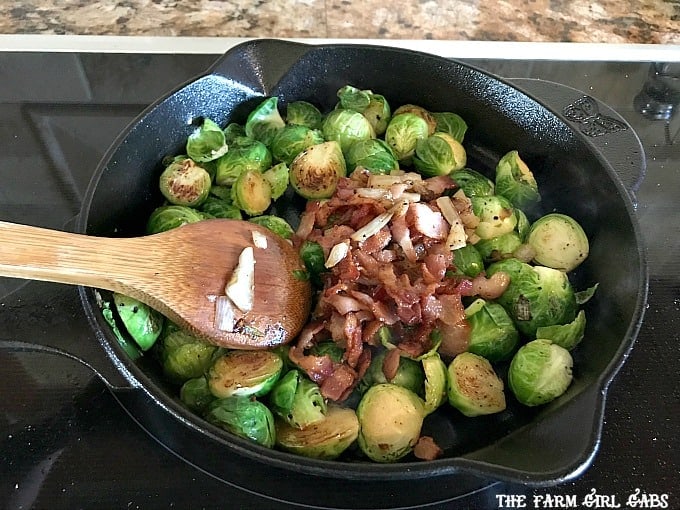 Pan Seared Brussels Sprouts With Bacon are a super quick side dish ready in 20 minutes flat! It's the perfect recipe to serve at Thanksgiving or for a weeknight meal. #SideDish #Recipe