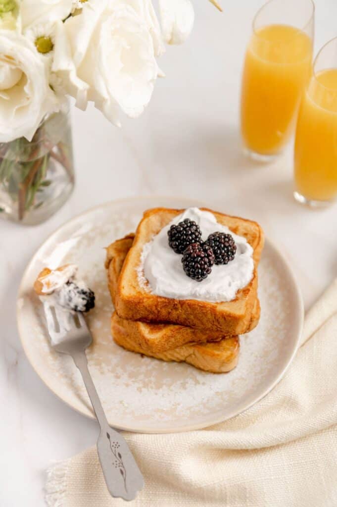 Antique fork with a bite of vegan French toast on it.