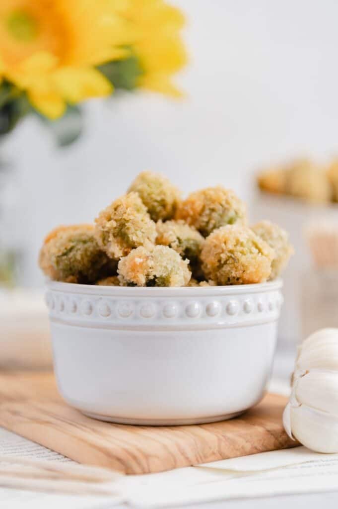 Olives stuffed with cream cheese and roasted garlic in a ramekin.