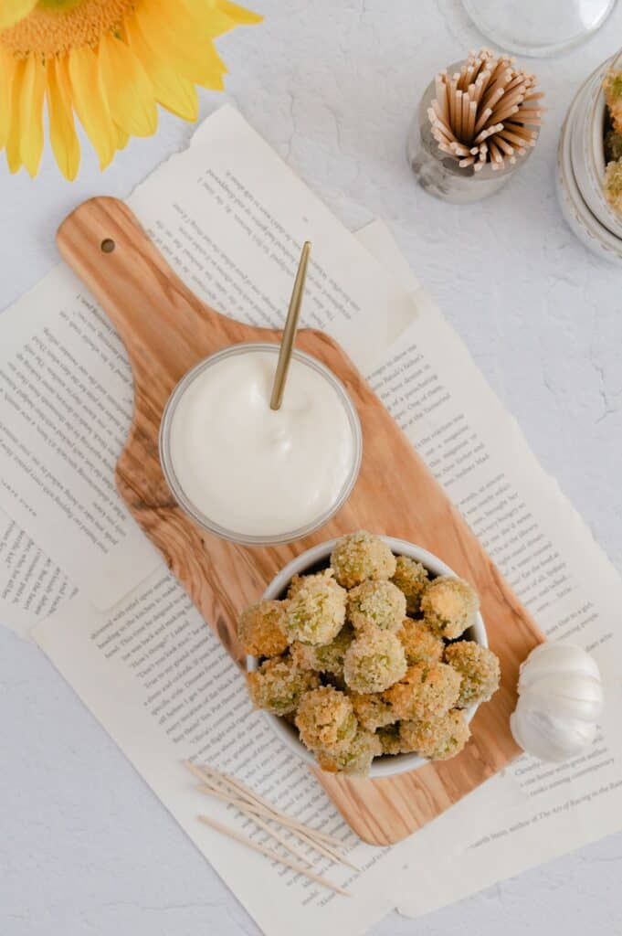 Overhead of vegan fried olives with garlic aioli dipping sauce.