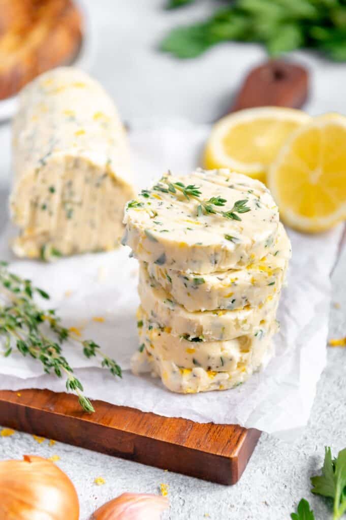 A stack of herb and shallot butter with fresh thyme on top.