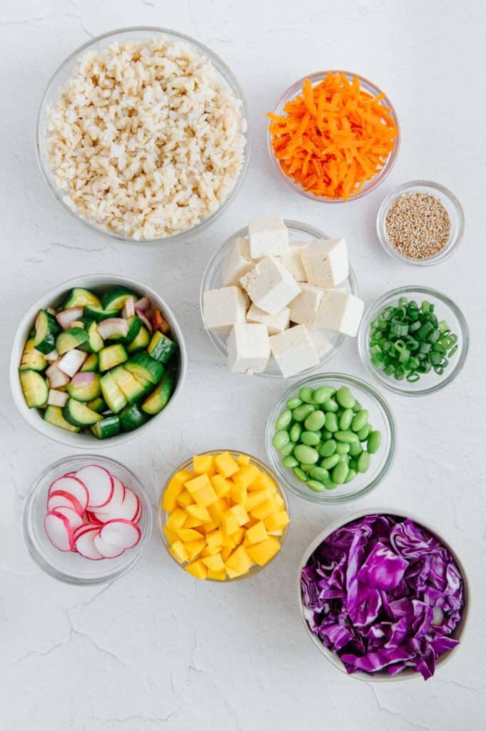 Ingredients to DIY a homemade poke bowl in separate bowls.