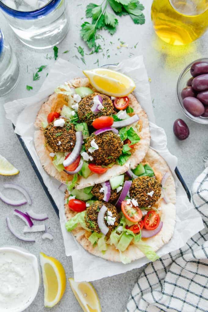 Two falafel sandwiches in a serving tray.