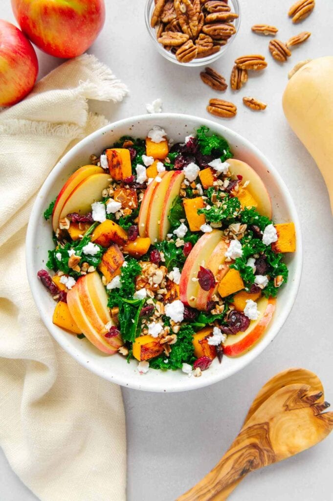 A vegan fall harvest salad with apples and butternut squash ready to be served.