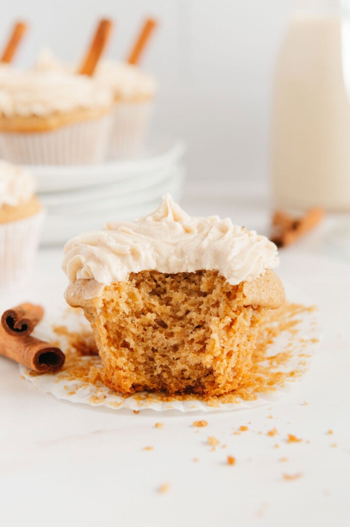 Upclose of a crumbly chai cupcake with a bite taken out of it.