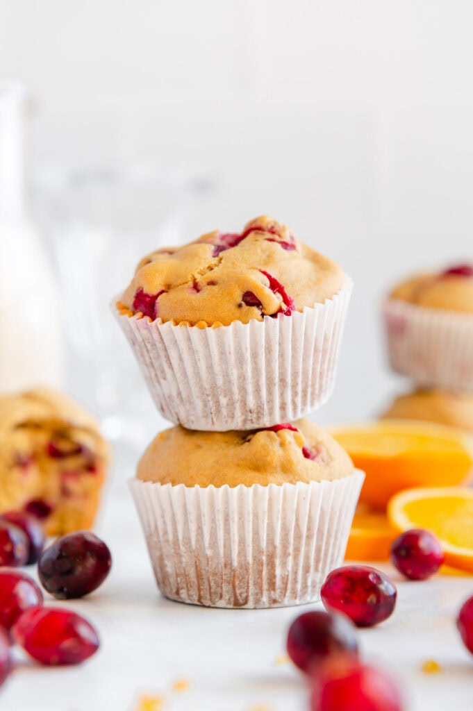 Two cranberry muffins stacked on top of one another.