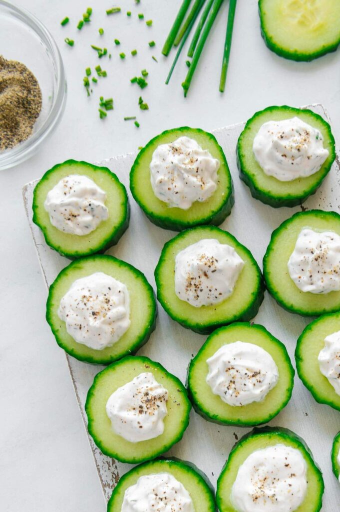 Upclose of vegan cucumber bites with fresh black pepper.