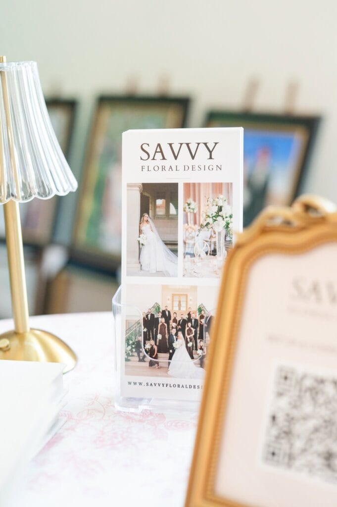 Gold mirror and floral design display with wedding photos at Romaine Valley Weddings & Events in Fenton, Missouri