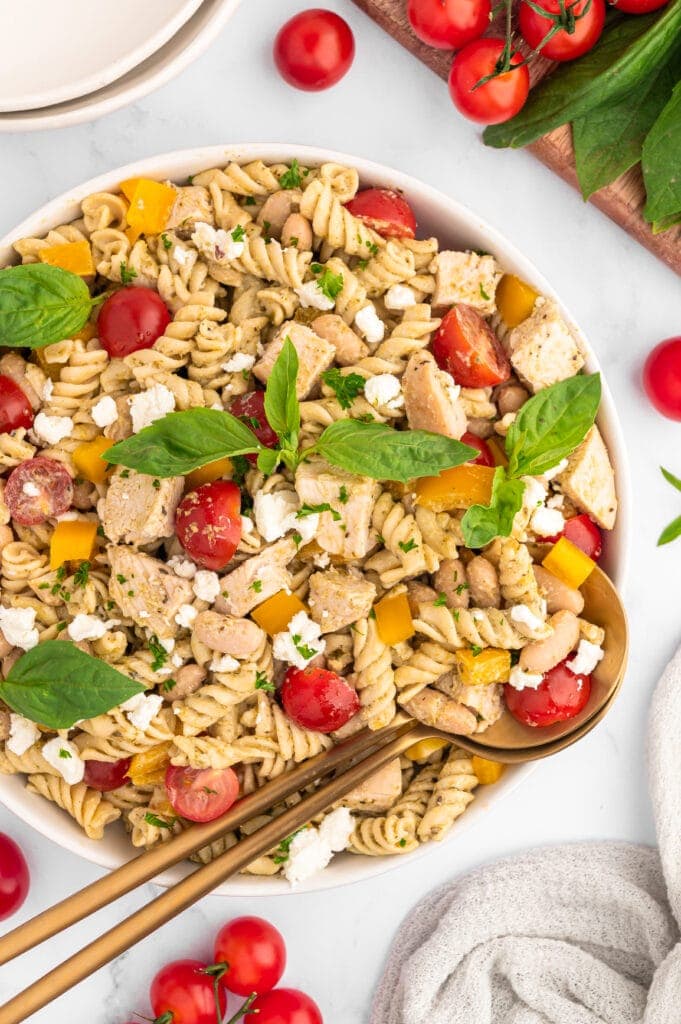Serving spoons in a bowl of High Protein Pasta Salad.