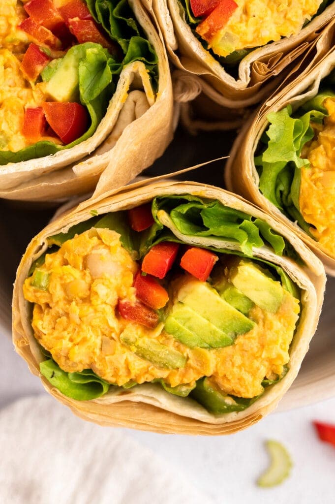 Overhead close up of Buffalo Chickpea Wraps halved standing on their sides.