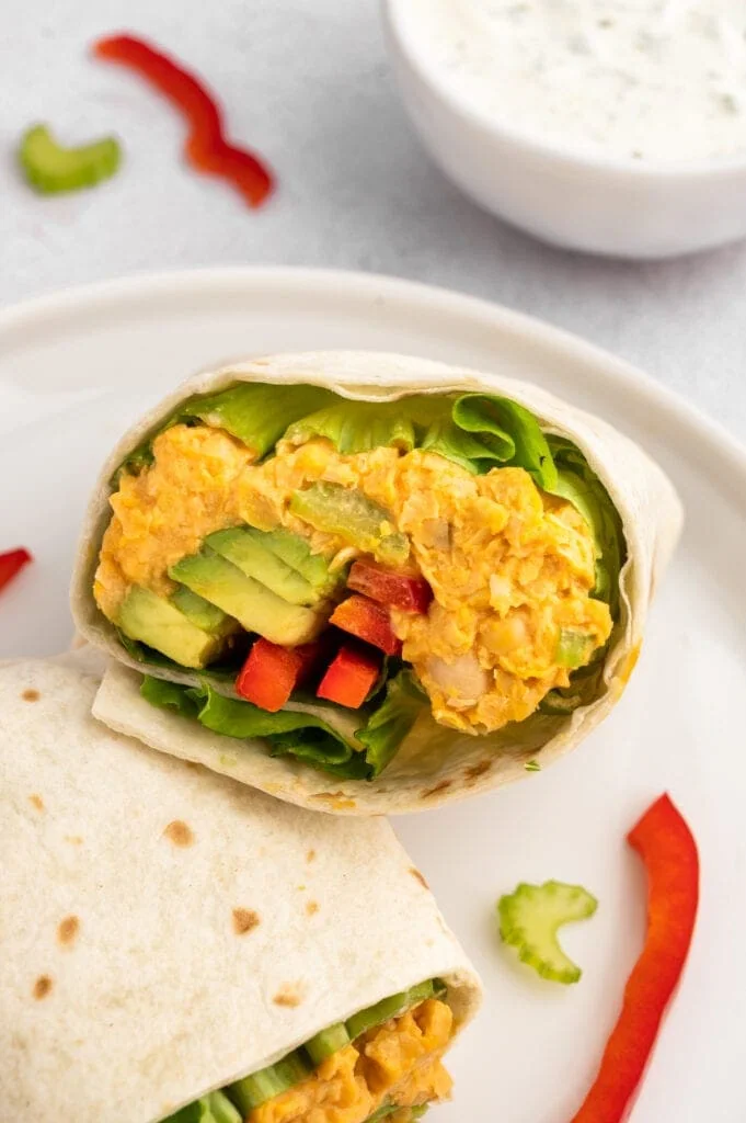 Close up of the inside of one half of a Buffalo Chickpea Wrap.