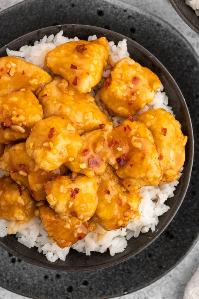 top view of air fryer orange chicken over a bed or rice.